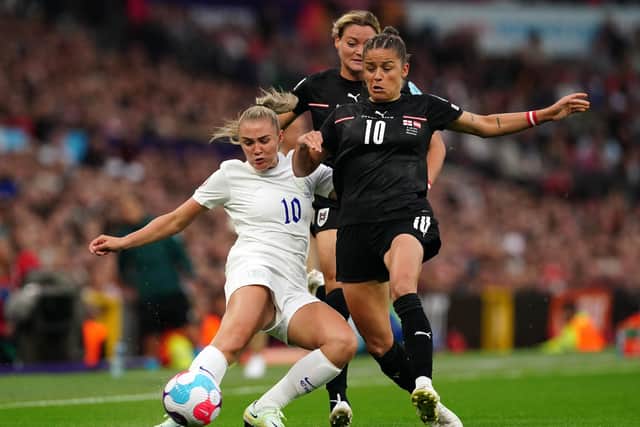 Tussle: England's Georgia Stanway (left) and Austria's Laura Feiersinger  battle for the ball at Old Trafford. Picture: Martin Rickett/PA Wire.