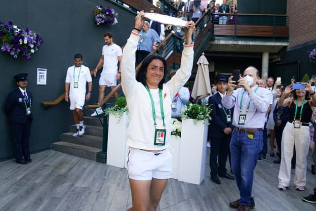 Ons Jabeur greets her supporters with the runners up trophy following defeat to Elena Rybakina in The Final of the Ladies' Singles (Picture: PA)