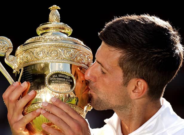 Novak Djokovic celebrates with the Trophy following his victory over Nick Kyrgios. Picture: Adam Davy/PA Wire.