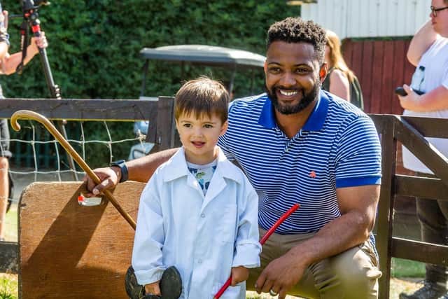 Young Pig handler Josh Kirby, aged 2, of York, with popstar turn farmer JB Gill, best known as a member of boy band JLS, taking the opportunity to handle a Tamworth pig whilst visiting the show. Writer: James Hardisty