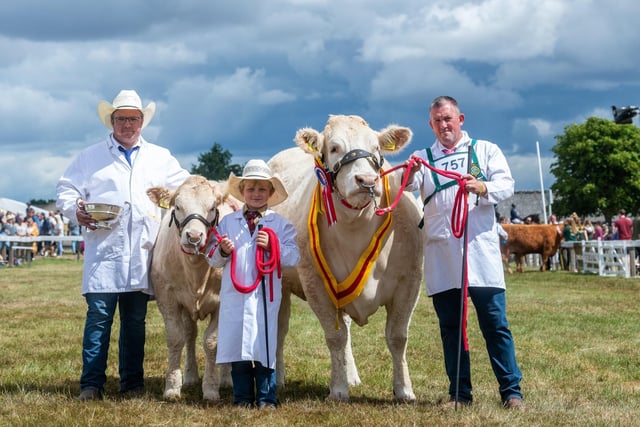 Thorn Atkinson, with his son Frankie, 8, of (Arradfoot & Newlands), Overston, Cumbria, and Steven O'Kane, (Farm Manager), hold their British Blonde which won the Supreme Beef Champion Class.