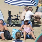 Where to go and what to see on a sunny day in Yorkshire according to the people who live there. Pictured: People enjoying the sunshine in Scarborough. PA.