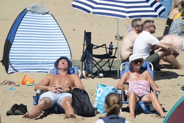 Where to go and what to see on a sunny day in Yorkshire according to the people who live there. Pictured: People enjoying the sunshine in Scarborough. PA.