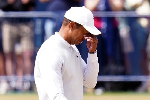 USA's Tiger Woods wipes his eyes on his way over the 18th as spectators applaud. Picture: PA