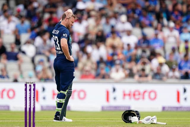 Painful blow: England's Jos Buttler holds his head after being hit by a ball during his innings. Picture: Mike Egerton/PA Wire.