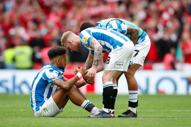 Huddersfield Town duo Lewis O'Brien and Tino Anjorin console team-mate Sorba Thomas after the Championship Play-off Final defeat to Nottingham Forest. (Photo by John Early/Getty Images)