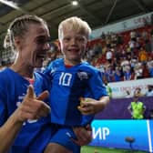 Iceland's Dagny Brynjarsdottir reacts with her child following their team's exit from Euro 2022. Picture: Tim Goode/PA