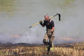 A firefighter in full kit walks in front of a wildfire in South Yorkshire [Image: South Yorkshire Fire and Rescue]