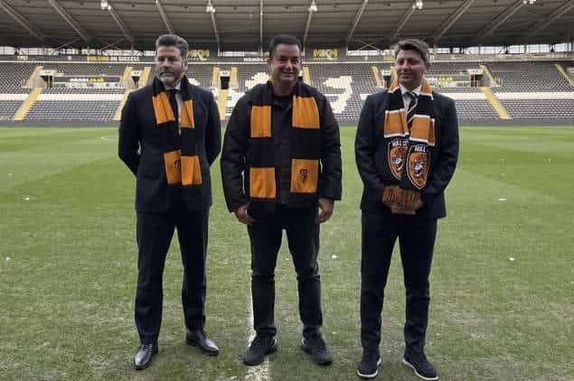 Hull City vice-chairman Tan Kesler (right), chairman and owner Acun Ilicali (centre) and CEO Jim Rodwell (left) pose for pictures on the pitch at their unveiling in the winter. Picture: PA