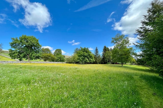 The property has a traditional grass meadow, mature trees and streamside setting within a plot extending to almost 2 acres.