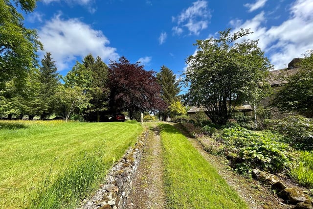 The property is accessed by a lane and is surrounded by natural beauty