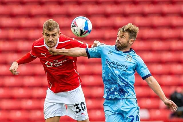 Michal Helik challenges Coventry's Matt Godden in last season's game at Oakwell. Picture: Bruce Rollinson