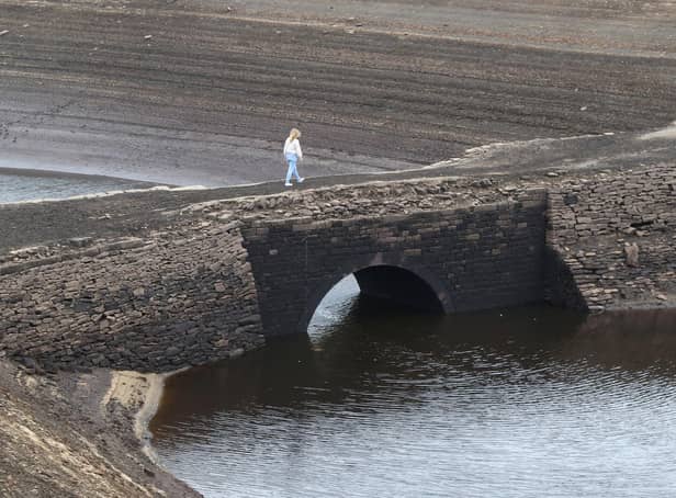 One solitary figure was pictured walking across the old Road Bridge at Baitings Reservoir, near Ripponden, West Yorks.