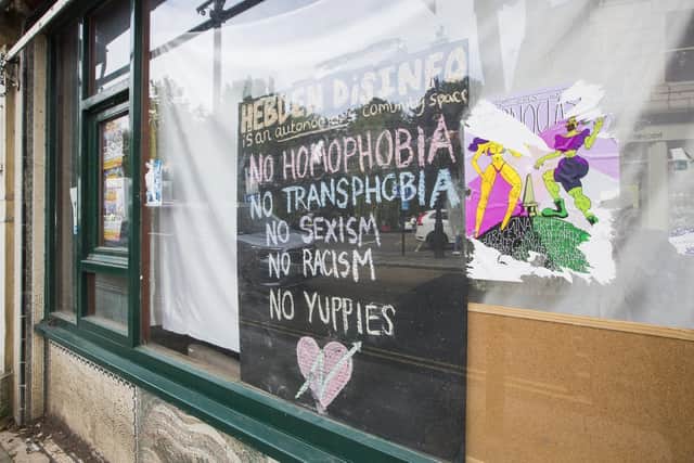 A sign in the window of the squat