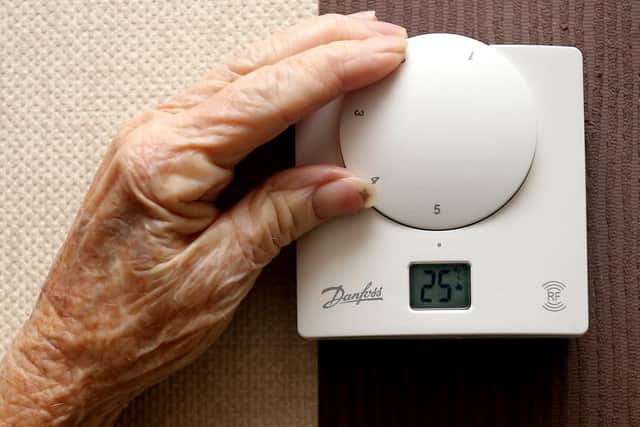 A lady adjusting her thermostat on at home in Liverpool. Picture: Peter Byrne/PA.