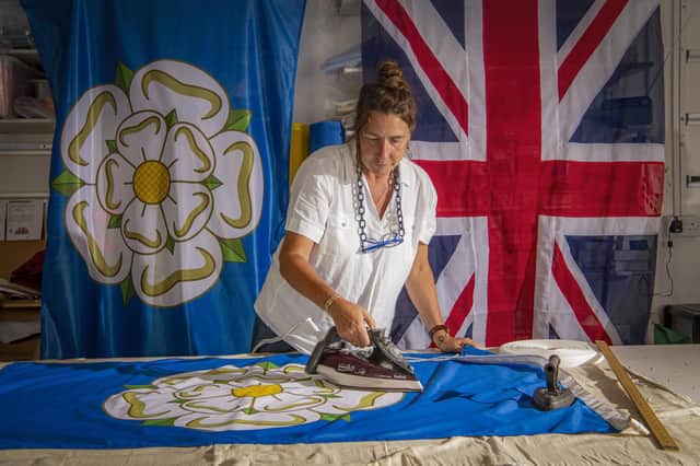 Dawn Banks presses a massive Yorkshire rose flag read for Yorkshire Day at Flying Colours in Knaresborough