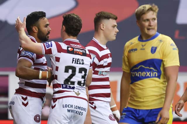 Will Tate appears dejected as Wigan Warriors celebrate Bevan French's opening try. (Picture: SWPix.com)