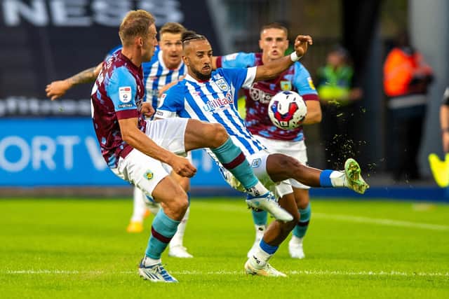 Huddersfield Town winger Sorba Thomas challenges Burnley defender and former Leeds United player Charlie Taylor. Picture: Bruce Rollinson.