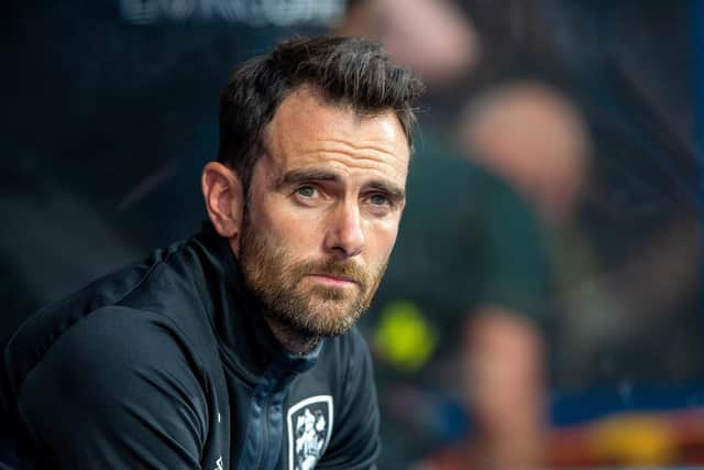 Pensive Huddersfield Town head coach Danny Schofield, pictured in the dug-out on his first match in full-time charge against Burnley on Friday night. Picture: Bruce Rollinson.