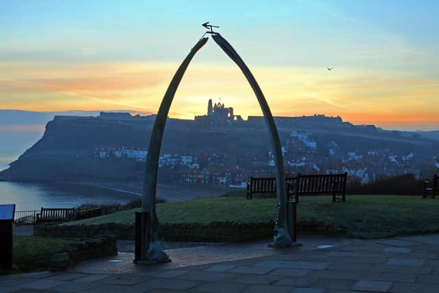 St Mary's Church and Whitby Abbey stand proud over the southside of the North Yorkshire harbour town at sunrise through the famous whale jawbones landmark Picture: Tony Johnson