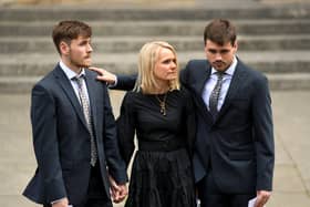 Helen Gration (centre) was comforted by her sons Harvey (left) and Harrison (right) at Harry Gration's funeral in York Minster on Monday