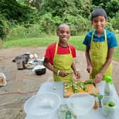 Children prepare salad as part of a Healthy Holidays Leeds activity. Photo: Hyde Park Source.