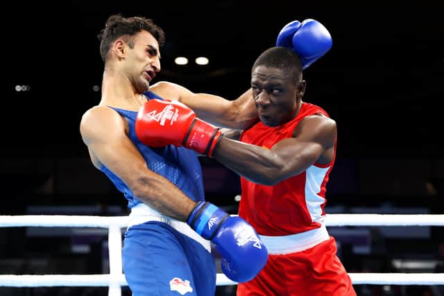 BIRMINGHAM, ENGLAND - AUGUST 02: Jessie Lartey Lartey of Team Ghana and Mohammed Harris Akbar of Team England exchange punches during the Men's Over 67kg-71kg (Light Middle) - Round of 16 fight on day five of the Birmingham 2022 Commonwealth Games at NEC Arena on August 02, 2022 in Birmingham, England. (Photo by Luke Walker/Getty Images)