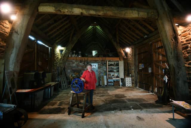 Helen Rhodes in the farm's restored 16th-century cruck barn