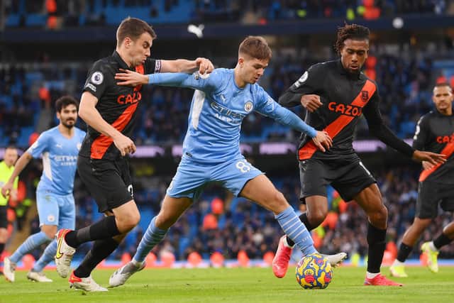 EARN IT: James McAtee of Manchester City battles for possession with Everton's Seamus Coleman at Etihad Stadium ni November last year Picture:Laurence Griffiths/Getty Images