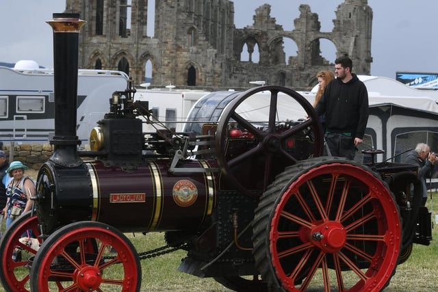 An engine with the abbey ruins in the background