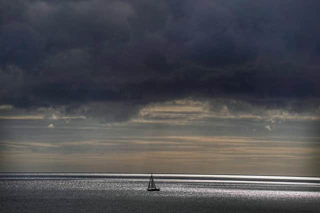 A yacht sails across the North Sea under storm clouds Picture: PA
