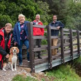 From left, Ellingstring resident Richard King with Merlin the dog, County Councillor Margaret Atkinson, Andrew McLean, public rights of way field officer, and Michael Leah, assistant director for Travel, Environment and Countryside Services, at Swinney Beck Bridge.