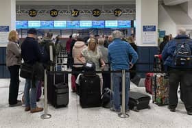 Library image of passengers queuing inside the departures area of Terminal 1 at Manchester Airport. Picture: PA