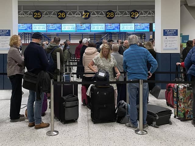 Library image of passengers queuing inside the departures area of Terminal 1 at Manchester Airport. Picture: PA