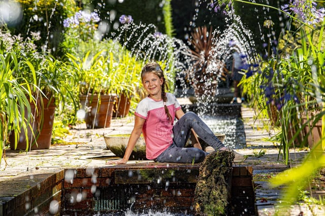 Aisa Eros, who is on holiday from Hungary, by the fountains in the Monet Gardens in Roundhay Park, Leeds.