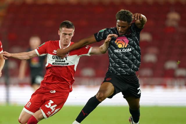 Middlesbrough's Daniel Dodds (left) and Barnsley's William Hondermarck battle for the ball during the Carabao Cup, first round match at the Riverside Stadium, Middlesbrough on Wednesday (Picture: PA)