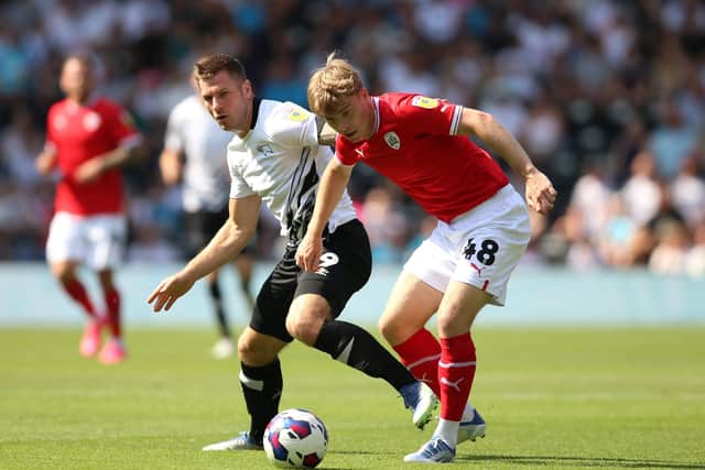 Derby County's James Collins (left) and Barnsley's Luca Connell in action (Picture: PA)