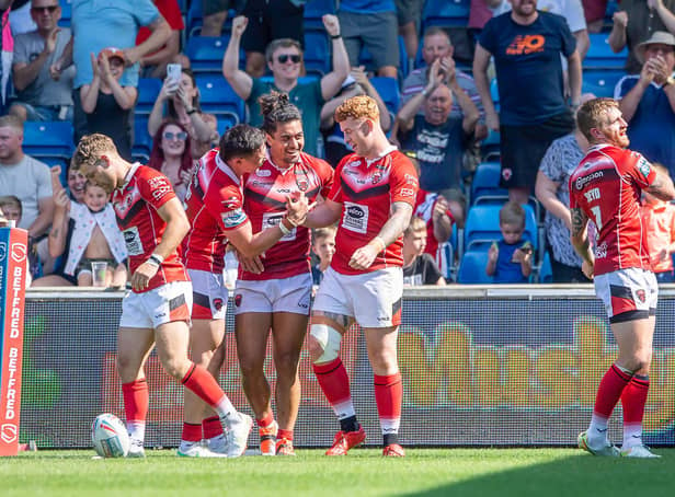 Picture by Allan McKenzie/SWpix.com - 13/08/2022 - Rugby League - Betfred Super League Round 23 - Salford Red Devils v Huddersfield Giants - AJ Bell Stadium, Salford, England - Salford's Harvey Livett (r) is congratulated on scoring a try against Huddersfield.
