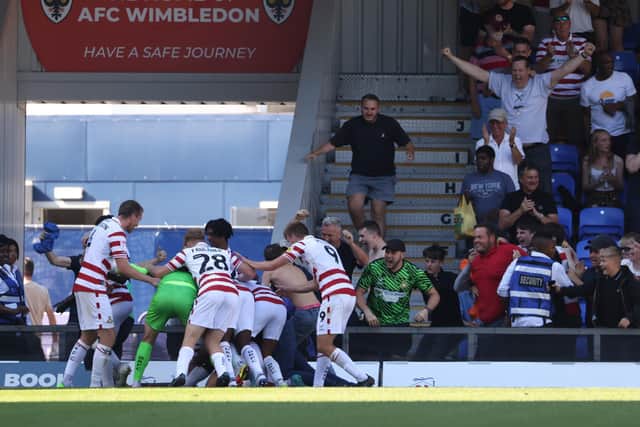 Doncaster’s Ro-Shaun Williams celebrates scoring their side's second goal of the game with team-mates during the Sky Bet League Two match at Cherry Red Records Stadium. Picture: James Manning/PA Wire.