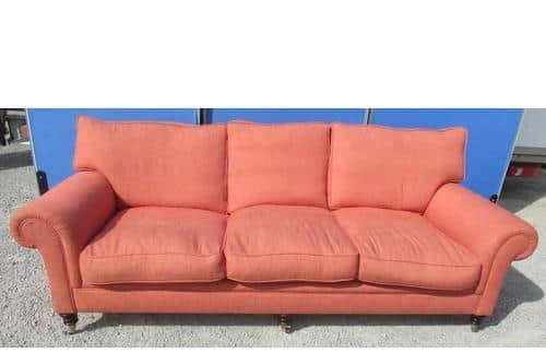 A salmon-coloured George Smith Howard style sofa, which has an estimate of £1,000 to £2,000  Credit: Ryedale Auctioneers