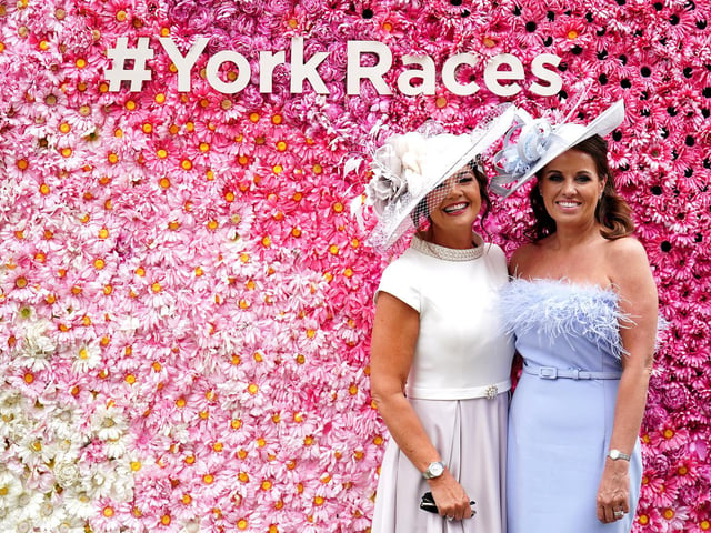 Racegoers pose for photographs during day two of the Ebor Festival at York Racecourse.