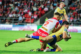 Got him: Robins' former Saint, Lachlan Coote, is tackled by Tommy Makinson. Picture: Alex Whitehead/SWpix.com