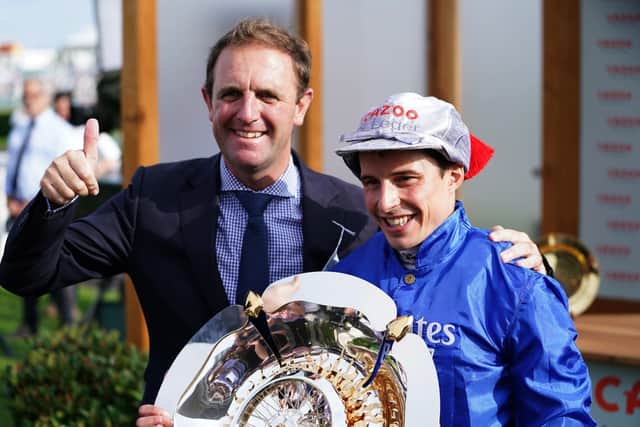 Trainer Charlie Appleby and jockey William Buick celebrate with the trophy after winning the Cazoo St Leger Stakes at Doncasterlast year. Picture: Mike Egerton/PA