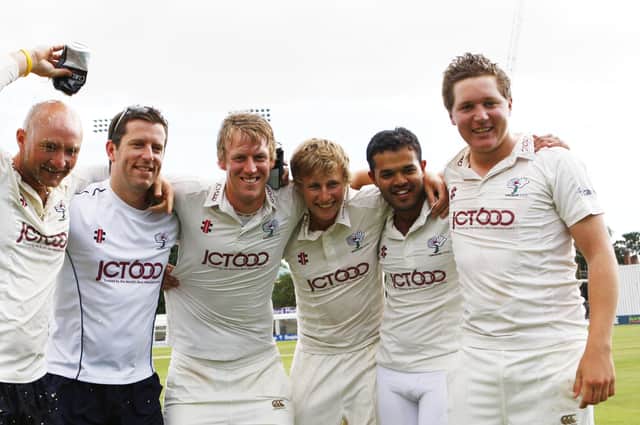 Azeem Rafiq (second right) and Gary Ballance (right) - pictured with Yorkshire team-mates and staff back in 2012 after the club had won promotion back to County Championship Division One. Picture: Keiran Galvin/SWPix.com