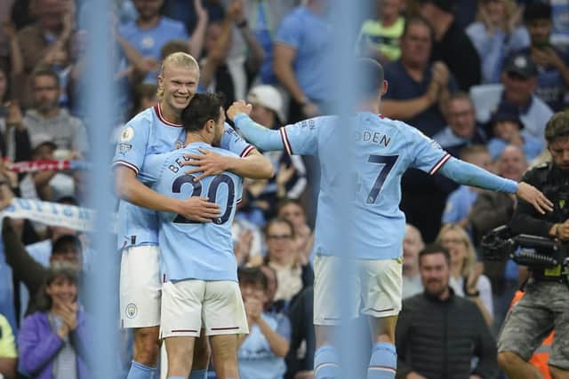 Manchester City's Erling Haaland, left, celebrates with teammates after scoring his side's second goal (AP Photo/Dave Thompson)