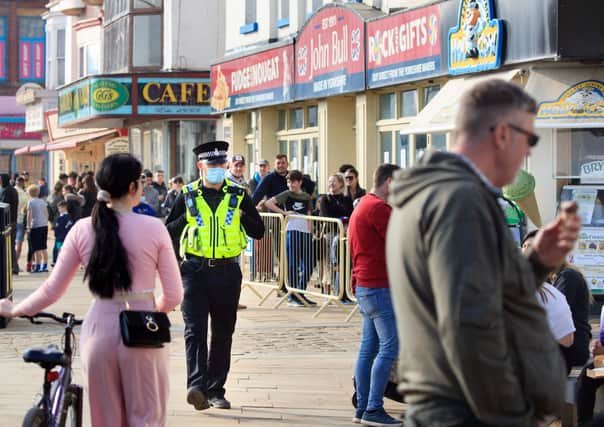 A police officer patrols Scarborough's seafront as the lockown is eased.