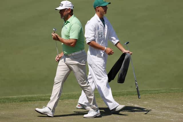 KEEP IT IN THE FAMILY: Lee Westwood and his caddie and son Sam Westwood look on from the third tee during a practice round prior to the Masters at Augusta National. Picture: Kevin C. Cox/Getty Images.