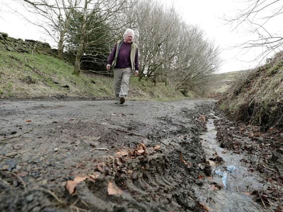 Holme Valley South councillor Donald Firth inspects damage to a green lane route used by bikers and 4×4 drivers. (Image: Andy Catchpool)