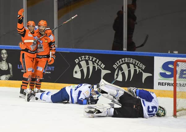 Liam Kirk helps Tanner Eberle celebrate his hat-trick strike for the Steelers against Coventry. Picture courtesy of Karl Denham/EIHL.
