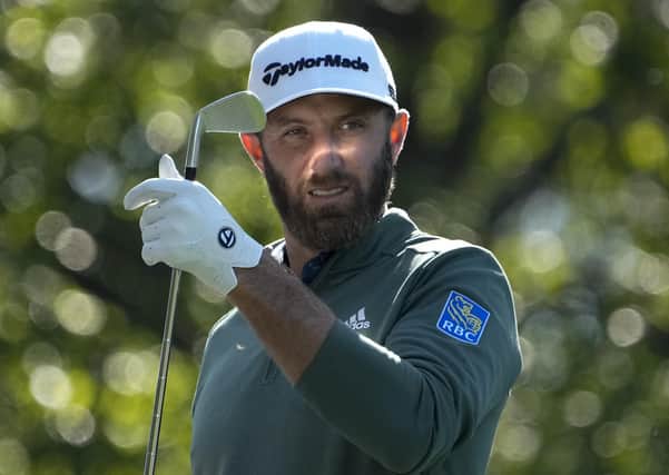 Dustin Johnson selects a club on the fourth hole during a practice round for the Masters. Picture: AP/David J. Phillip